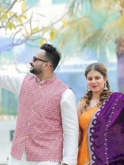 A fun and colorful couple portrait from their Haldi ceremony, using smoke guns to create a vibrant and playful backdrop.