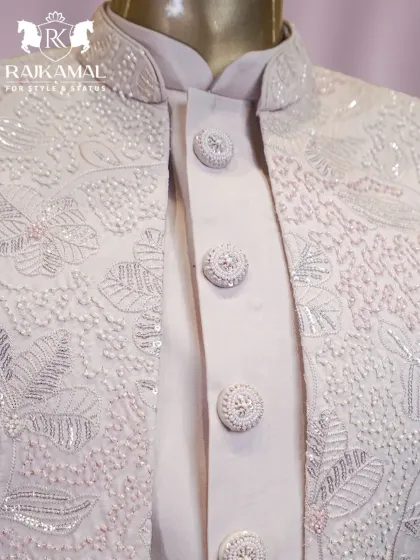 Another look at the handcrafted buttons and floral embroidery on the white Indo-Western ensemble.