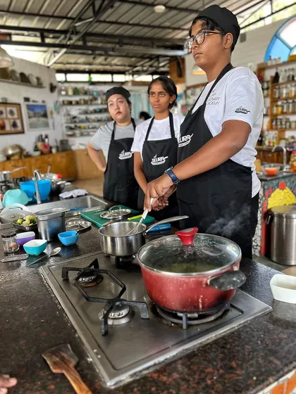 Students in our academy kitchen, listening intently during a lesson on stocks and sauces.