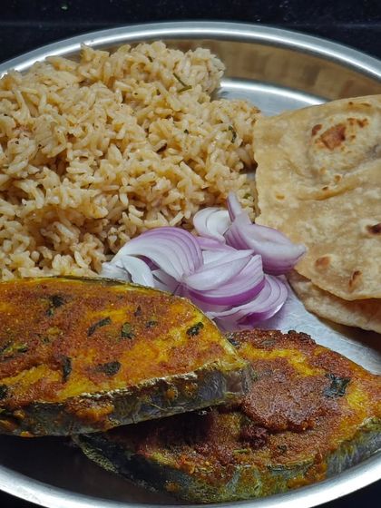 A plate of simple ghar ka khana (home food) featuring Surmai Fish Fry and a Madurai Mutton Biryani. This shows how I love to combine flavours from different regions in one satisfying meal.