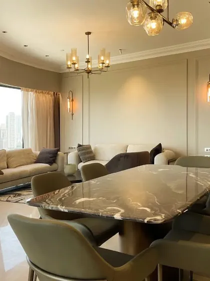 An open-concept living and dining area designed to maximize light and views. The cohesive color palette and elegant furniture create a sophisticated and harmonious space for both relaxing and entertaining.