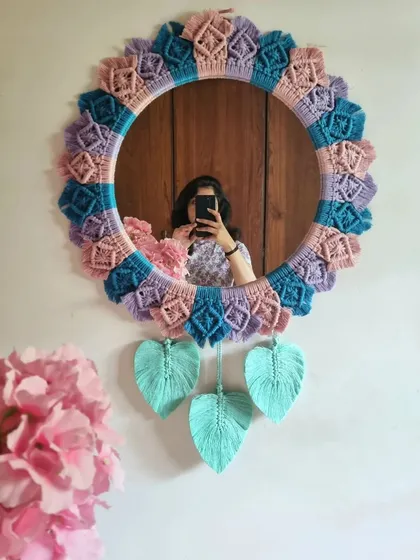 Why shouldn't functional items be beautiful? We handcrafted this macrame mirror with a love for pastels and boho design, creating a one-of-a-kind piece that is both a useful mirror and a stunning piece of wall art.