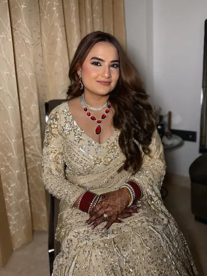 A seated portrait of my client for her reception. The makeup is soft and glamorous, with a focus on radiant skin and defined eyes.