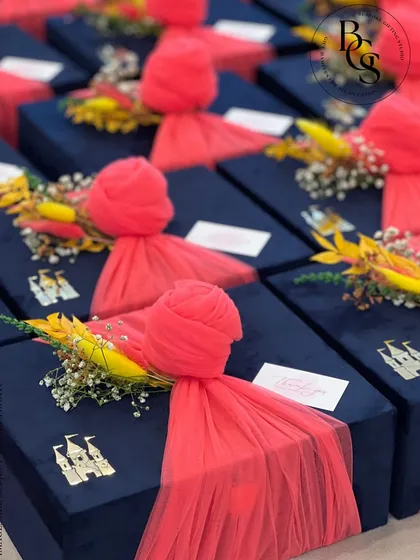 A detailed shot of our navy velvet boxes with bright pink fabric accents. This image highlights the custom castle charm attached to the box, showing how we can incorporate unique, personalized elements into your gifts.