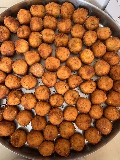 A large tray of Corn & Cheese Balls, ready for a birthday party of over 100 people.