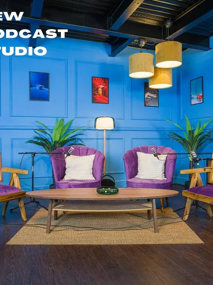 A look at our new, fully-equipped podcast studio. The vibrant blue walls, modern furniture, and professional microphones make it the ideal space for creators and businesses to record high-quality audio and video content.