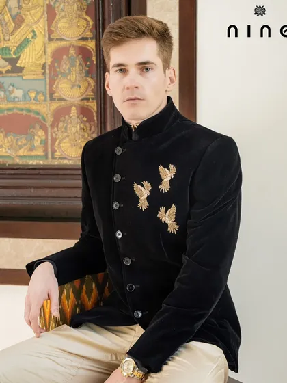 A portrait of quiet confidence. The antique gold embroidery on the black velvet bandhgala provides a rich contrast, creating a look that is both timeless and memorable.