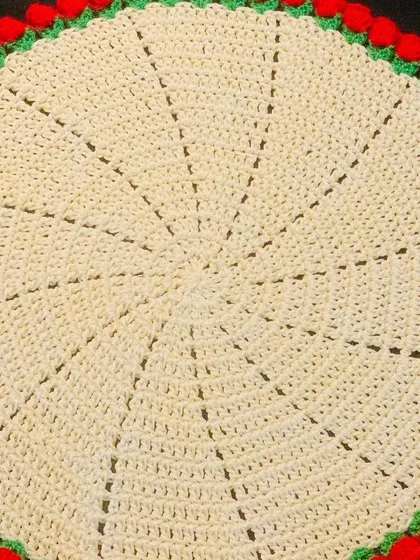 A cream-colored doily with a classic red tulip border. This design is simple, elegant, and festive.