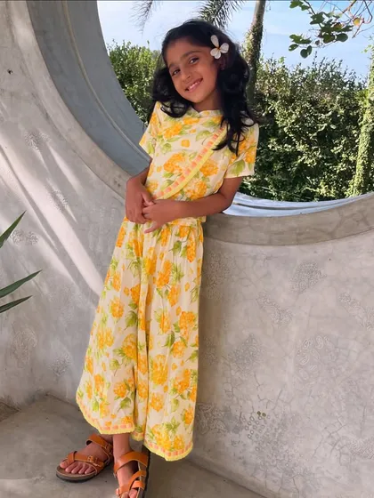 Another look at our sunny floral set. The smile on her face and the flower in her hair say it all. It's a happy outfit for a happy girl.