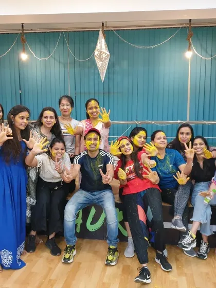 Hands full of color and hearts full of joy! Our students and instructor pose for a group photo during our super fun Holi celebration at the studio.