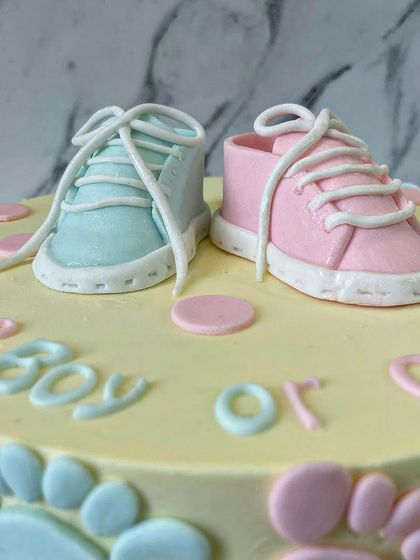 A close-up of the incredibly detailed fondant baby shoes. I love making these tiny toppers; they are the perfect keepsake from a special celebration.