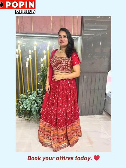 Another shot of the client in the red lehenga, with a clear call to action to book your outfits today.
