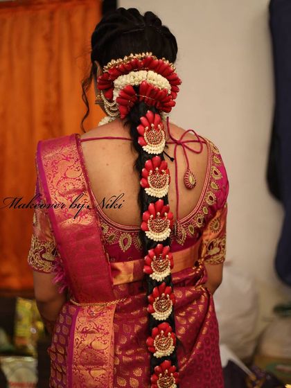 A detailed look at the stunning traditional floral braid for Pooja's second varpooje look. This kind of intricate hair art is a hallmark of South Indian weddings.