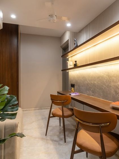A perfect balance between productivity and peace. This serene study space features stunning walnut veneer wardrobes for a rich, natural warmth, and a plush sofa seating area for moments of rest and reflection.