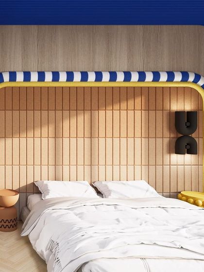 The bedroom in "Whimsy Wonder" features a playful headboard with a blue and white striped frame, set against a wall of vertical wooden tiles.