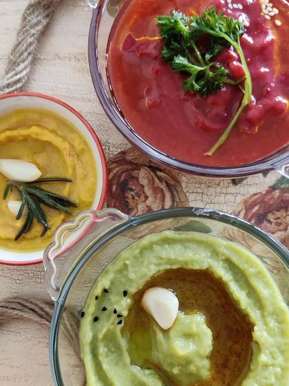 A trio of our homemade hummus flavours: vibrant Beetroot Hummus, classic Chickpea Hummus, and fresh Green Pea Hummus. These dips are vegan and perfect with pita, veggies, or in wraps.