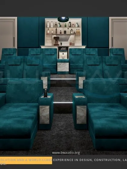 We designed this unique theater with a combination of tiered recliners and front-row chaise lounges in a striking teal fabric. This layout offers flexible, luxurious comfort, complete with a built-in mini-bar for the ultimate convenience.
