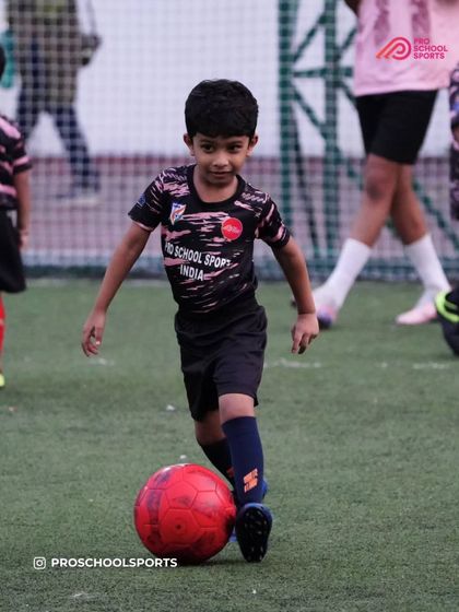 A young player shows great focus and control with the ball at their feet.