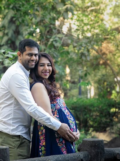 A loving embrace from behind during an outdoor session. This pose works beautifully in any setting, from a park to the beach.