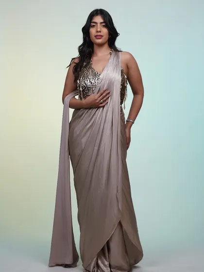 A full-length shot of the metallic pre-draped saree, showing its elegant drape and shimmering fabric.