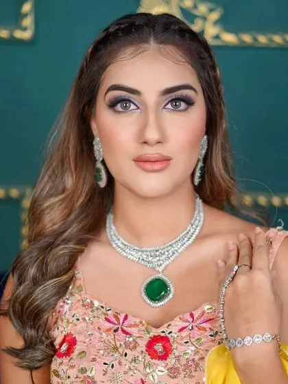 A beautiful close-up of the model, showcasing the intricate design of the necklace and matching earrings.