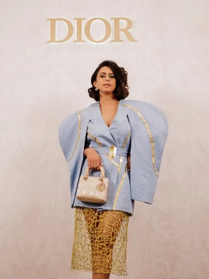Here is the full look for the Dior event, set against the brand's iconic logo. The makeup and hair work together to create a polished, high-fashion appearance suitable for a luxury brand gathering.