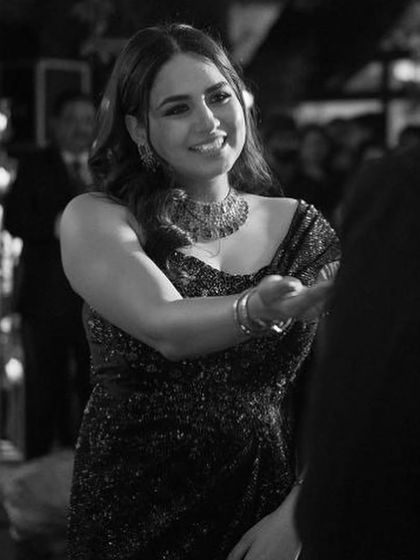 A black and white shot that captures the timeless elegance of a bridal solo. Her expression is full of love and happiness.