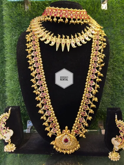 Another view of a traditional temple jewellery set, showcasing the beautiful craftsmanship and ruby-colored stones.