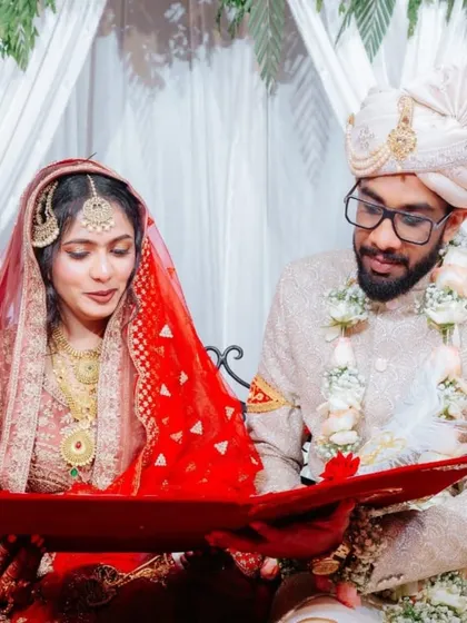 A candid moment of the bride and groom reviewing their Nikah nama, presented in a rich red velvet folder. Every detail is designed to feel special and personal.