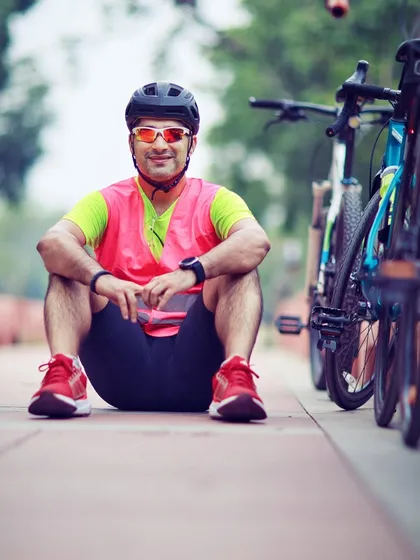 A member in a high-visibility vest, sitting with his bike. Safety is a top priority on all our rides.