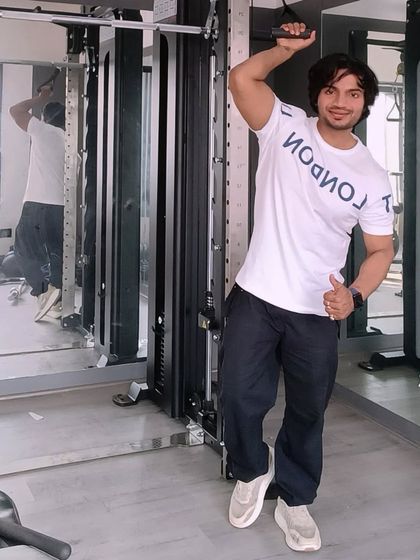 Feeling energized after a great workout. Using the lat pulldown machine is great for building a wide, strong back.