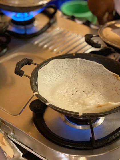 The perfect appam, fresh off the pan. These soft, lacey rice pancakes are a specialty of ours and are best enjoyed hot with a side of delicious chicken or vegetable stew.