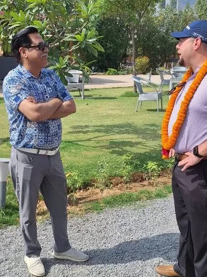 Visiting PGA Pro and Coach Matthew Reese discussing golf with a member at our academy, highlighting our commitment to bringing global expertise to our players.