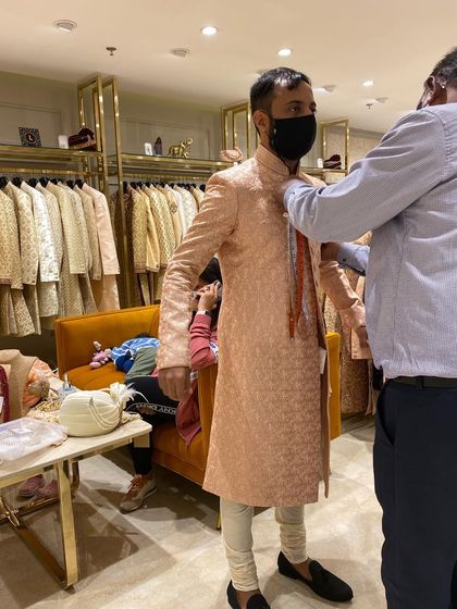 A glimpse of a groom's trial session. As a stylist, I am there for every fitting to ensure the sherwani is tailored to perfection for both comfort and style.