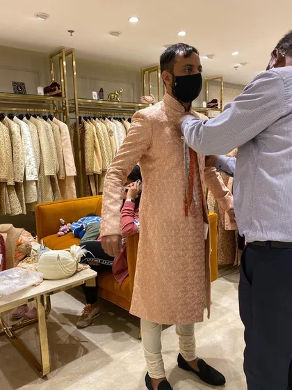 A glimpse of a groom's trial session. As a stylist, I am there for every fitting to ensure the sherwani is tailored to perfection for both comfort and style.