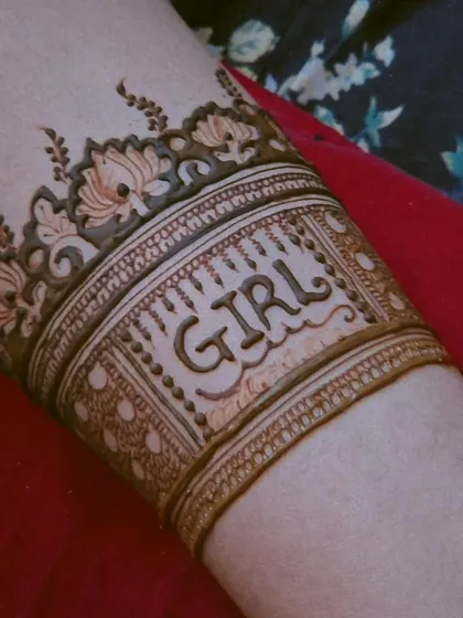 Another view of the 'GIRL' lettering on the arm, framed by a beautiful lotus border. The lines are clean and the design is very clear.
