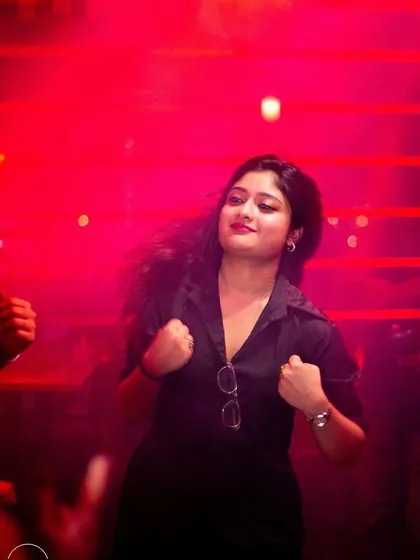 A dancer feeling the beat under the red lights at Toyboy Advant.
