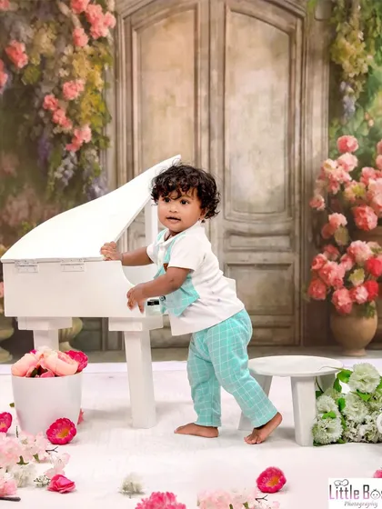 A little musician exploring the piano in a beautiful floral studio setting. This theme is perfect for capturing a child's curiosity and love for music.