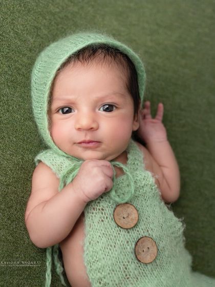 "Are you talking to me?" This nine-day-old's direct gaze and funny expression show that boss babies come in all sizes.