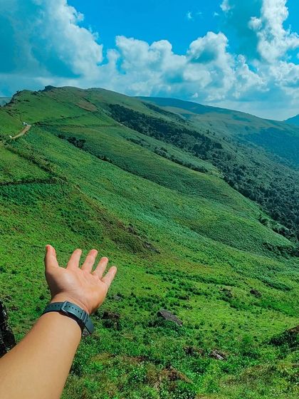 Reaching out to the vast green expanse of the Western Ghats.