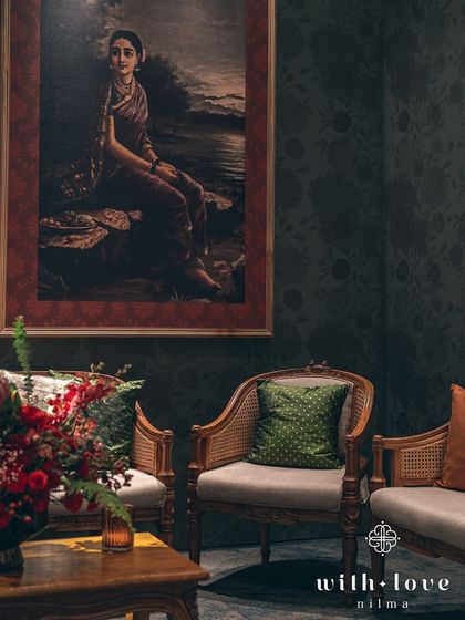 A quiet corner with classic cane-back chairs and a beautiful floral arrangement. These spaces are designed for guests to relax and soak in the artistic ambiance.