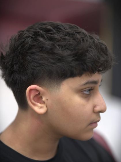 A close-up of the finished taper fade. The blend from short to long is seamless.