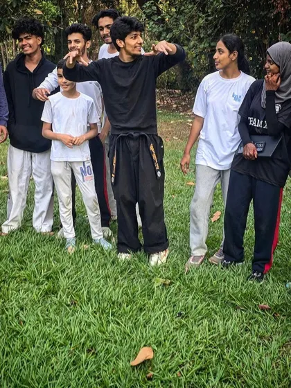 A candid group photo with some of my students in the park, capturing the relaxed and friendly atmosphere of our community.