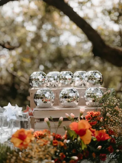 Votive candles made from miniature disco balls, a quirky and fun detail from the garden wedding bar.