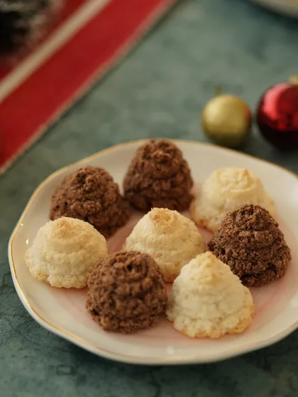 A plate of chocolate and coconut macaroons, styled with Christmas ornaments for a simple yet festive shot.