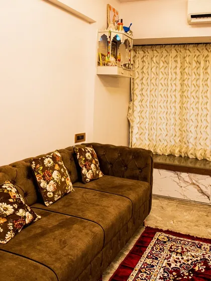 A comfortable window seat provides extra seating and a perfect nook for relaxation, complemented by a small mandir for spiritual tranquility.