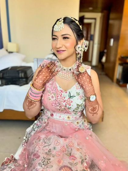 A happy and confident portrait, showing the complete look with hair, makeup, and jewelry.