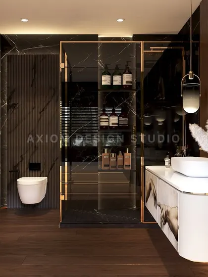 The washroom includes a floating toilet and a glass-enclosed storage unit with gold framing, adding to the rich, layered feel.