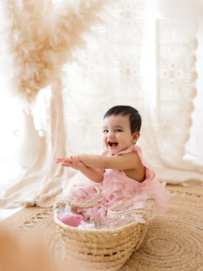 A burst of laughter from a happy baby in a basket. These candid, joyful moments are what make sitter sessions so special.