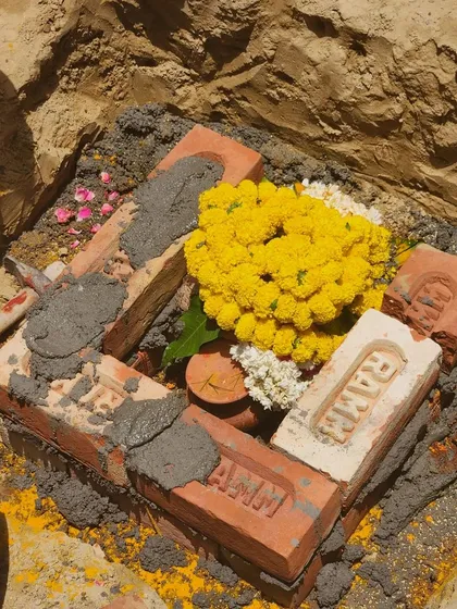 A close-up of the foundation stone during the bhoomi poojan for the Venkateswar hospital in Rohini. This ceremony marks the official start of construction, a process I manage from this very first day.